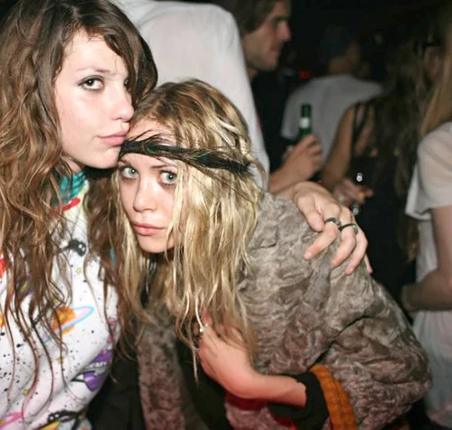 Models with smudged black eyeliner and tousled bedhead hair.